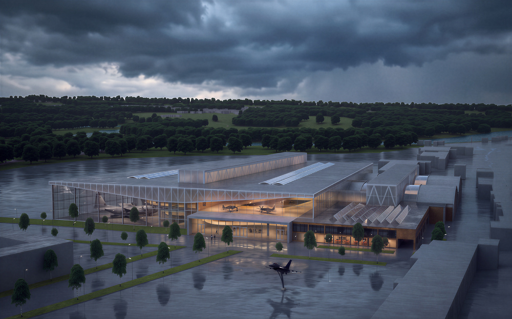 Anlegget sett fra forplassen i skumring, med utstillingen opplyst bak glassfasaden